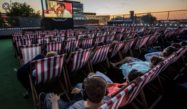 Outdoor cinema with LED screen and wireless headphones